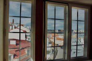 a view of a city from an open window at Skyview Hostel in Tallinn