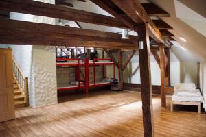 a room with a loft with a red bunk bed at Skyview Hostel in Tallinn
