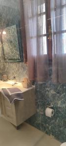 a bathroom with a sink and a mirror at A&Bpikermistudios in Pikérmion +14 photos