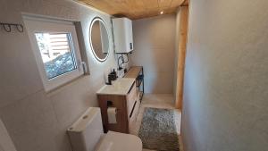 a bathroom with a toilet and a sink and a window at Domki pod Pilskiem in Korbielów +80 photos
