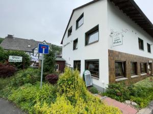 a white building with street signs in front of it at Hotel Haus Erlen in Olsberg