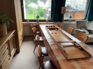 a room with a large wooden table and chairs at Hotel Haus Erlen in Olsberg