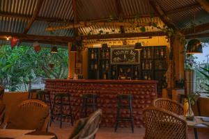 a bar in a restaurant with tables and stools at Sunsetview Safari Lodge in Bardiyā