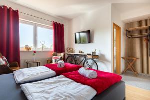 a bedroom with two beds with towels on them at Hotel Restaurant Litermont in Nalbach