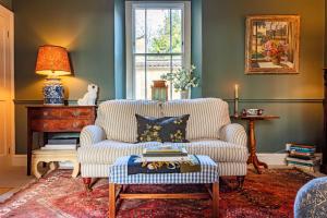 a living room with a couch and a table at Grand Georgian Residence in Bath