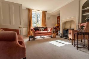 a living room with a couch and a fireplace at Grand Georgian Residence in Bath +77 photos