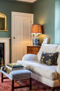 a living room with a white couch and a lamp at Grand Georgian Residence in Bath