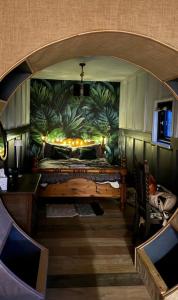 a room with a large bed with a mural at Acorn Cabin in Welshpool