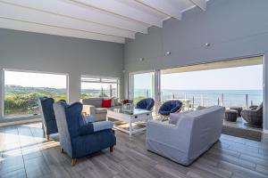 a living room with a view of the ocean at Klipfontein House in Kleinbaai