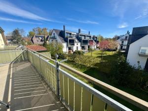 a balcony with a fence and some houses at Altes Wasserwerk App 22 in Wustrow