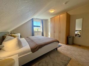 a bedroom with a bed and a window at Altes Wasserwerk App 22 in Wustrow