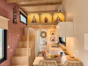 a tiny house with a kitchen and a dining room at Tiny Escape in São Miguel do Mato