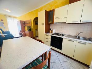 a kitchen with white cabinets and a counter top at Suite Semeria 44 - Sanremo in Sanremo