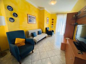 a living room with a couch and a tv at Suite Semeria 44 - Sanremo in Sanremo