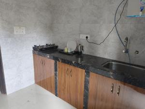 a kitchen with a sink and a counter top at Coconut Inn - Parra Goa in Mapusa