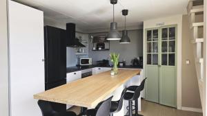 a kitchen with a wooden table and black chairs at Cozy seaside cottage SE09169 in Myggenäs