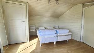 a small bedroom with a bed in a room at Cozy seaside cottage SE09169 in Myggenäs