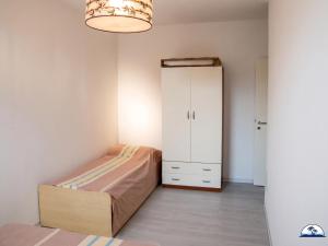 a small bedroom with a bed and a cabinet at La Mozza 739 in Torre San Giovanni Ugento