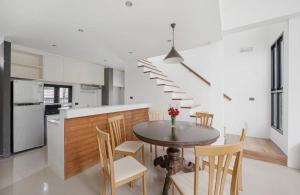 a kitchen and dining room with a table and stairs at Anas house in Lipa Noi in Lipa Noi