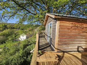 a wooden ramp leading up to a building at Cosy Treehouse in Pontypool