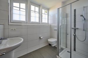 a bathroom with a toilet and a sink and a shower at Haus Strandbrise Graal-Müritz in Graal-Müritz +12 photos