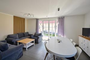 a living room with a couch and a table at Haus Strandbrise Graal-Müritz in Graal-Müritz