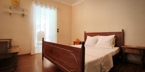 a bedroom with a bed with white sheets and a window at Soa Refuge in Antananarivo +6 photos