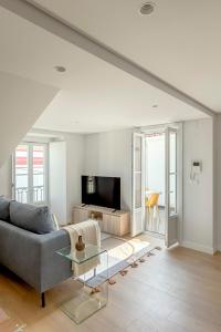 a living room with a couch and a tv at Casablanca 2BR Horizon in Caparica +37 photos