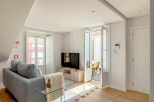a living room with a couch and a television at Casablanca 2BR Horizon in Caparica