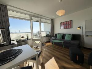 a living room with a couch and a table at Strandhotel - 19 "Sardinenbüchse" in Dahme