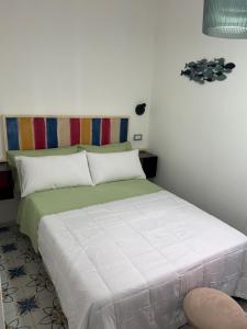 a bedroom with a bed and a chair at MARIMA' la Casa Vacanze - Holidays Suites in Maratea