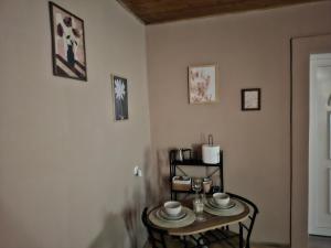 a room with a table and two chairs and a door at NeNa Apartmani - Ruma #2 in Ruma