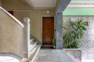a stairway with a wooden door and some plants at Seixal River Retreat in Amora