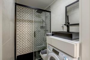 a bathroom with a sink and a washing machine at Seixal River Retreat in Amora +29 photos