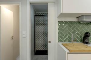 a bathroom with a shower with a sink and a counter at Seixal River Retreat in Amora