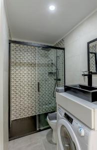 a bathroom with a washing machine and a toilet at Seixal River Retreat in Amora
