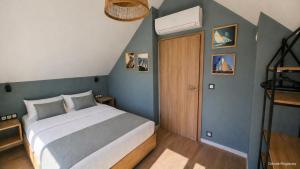 a bedroom with a bed and a wooden door at Jesionowa 3 Domki in Rowy