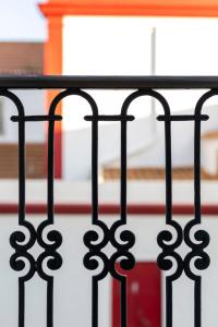 a black iron fence with a staircase in the background at Vienna 1BR Calm & Cozy Escape in Caparica