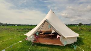 a large white tent in a field of grass at The Old Airfield Campsite in Bransgore