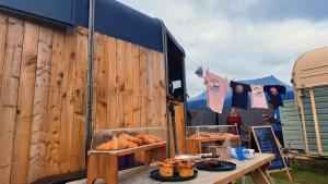 a food truck with bread and pastries on a table at The Old Airfield Campsite in Bransgore