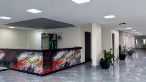 a lobby with a colorful counter in a building at Flat 55 Goiania in Goiânia +1 photo