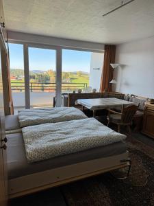 a bedroom with a bed and a large window at FeWo Luisa in Neureichenau