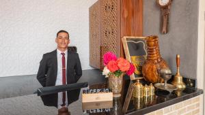 a statue of a man in a suit and tie on a counter at Igrane House - Resort & Spa in Aït Faska +69 photos