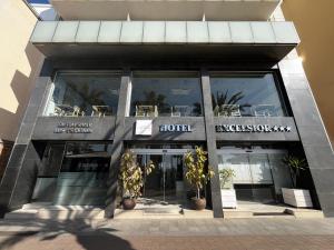 a store front of a hotel with potted plants at Hotel Excelsior in Lloret de Mar