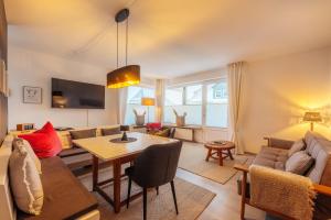 a living room with a couch and a table at Halali Braunlage in Braunlage