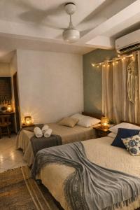 a bedroom with two beds and two lights on the ceiling at Pousada Sereia Morena in Florianópolis +50 photos