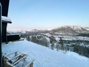 a snow covered roof with a view of a mountain at Authentic Cabin Life With Løefjell View in Rysstad
