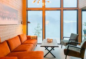 a living room with a couch and a table at Authentic Cabin Life With Løefjell View in Rysstad