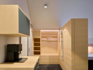 a kitchen with wooden cabinets and a refrigerator at Wohnen an der Mühlenwiese in Bad Sobernheim