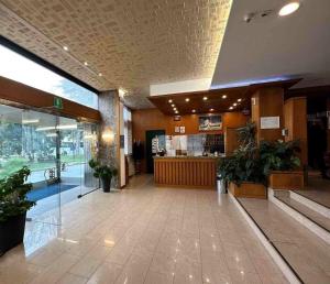 a lobby of a shopping center with a restaurant at Hotel Cristallo in Udine +130 photos